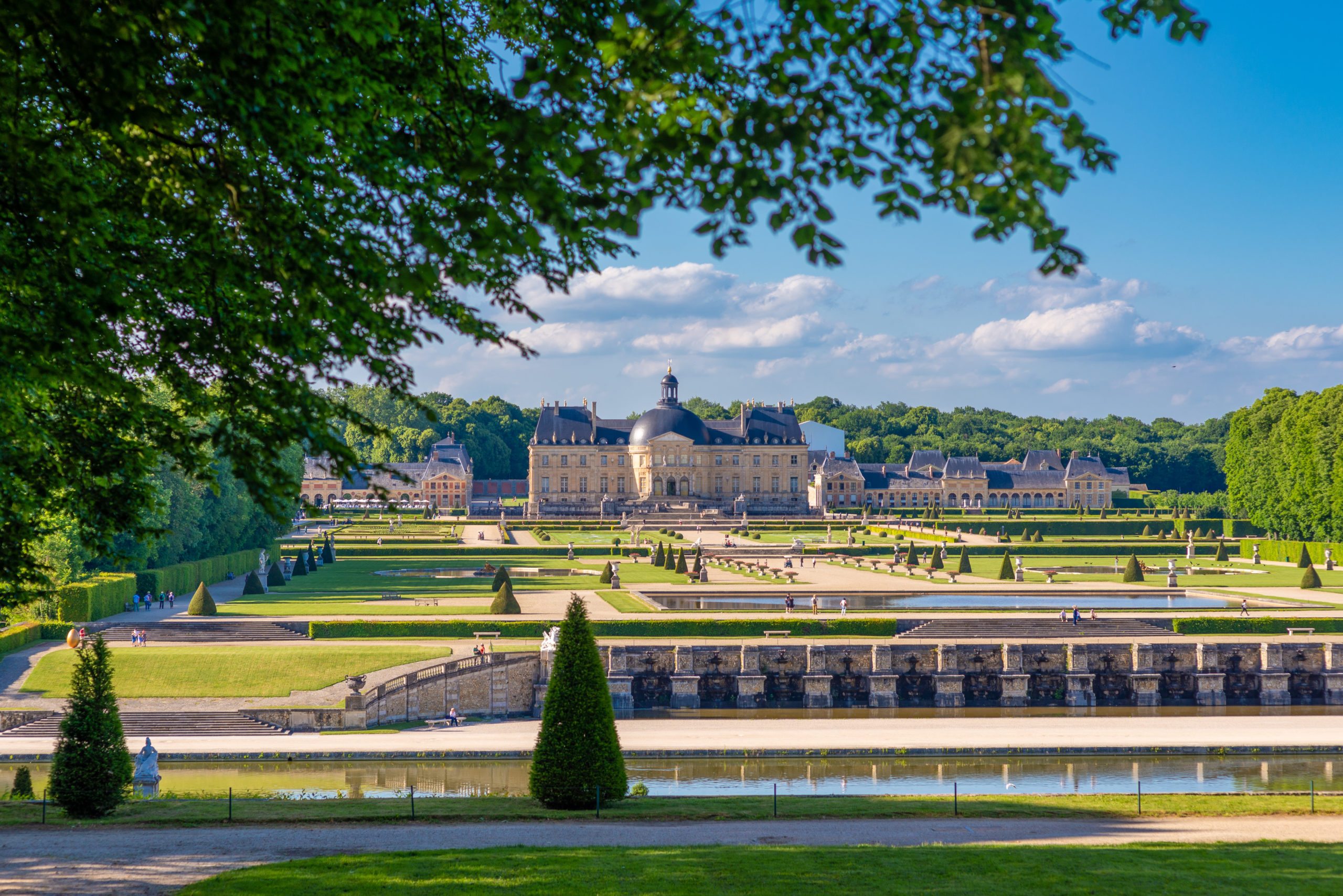 castle sets on the main perspective of a french classical garden (vaux le vicomte)